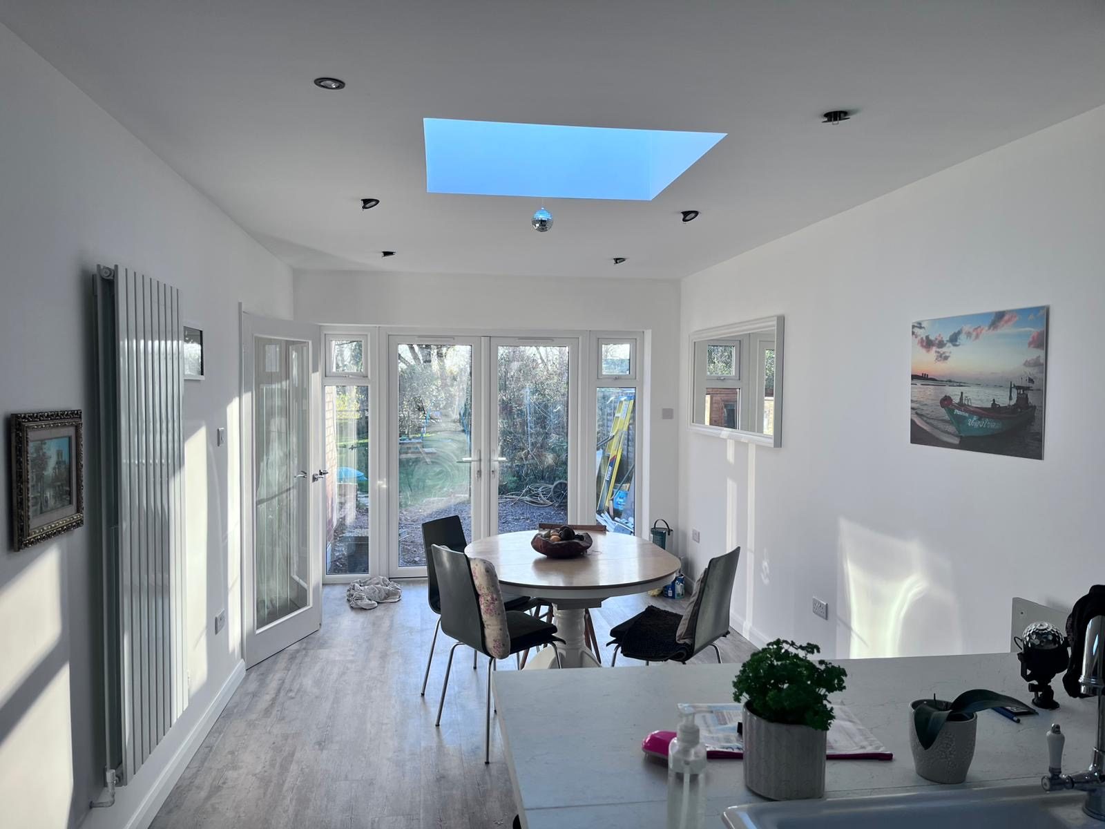 Bright garden room extension with a roof lantern and French doors